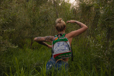 TORRAIN Recycled Bags, Designed in Portland, Oregon : Small backpack in white and green colorway print worn on a women on a hike